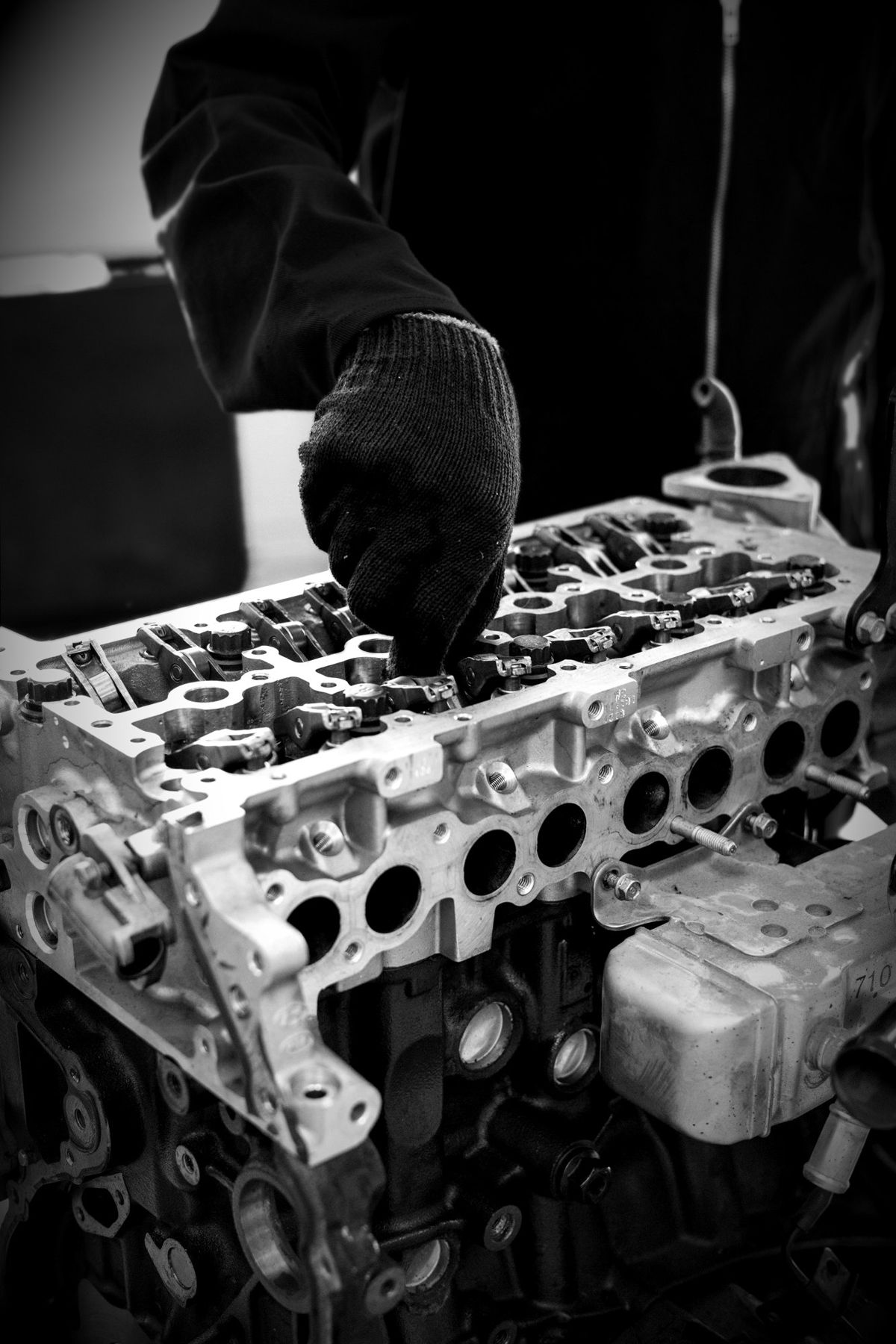 Mechanic in gloves working on an engine
